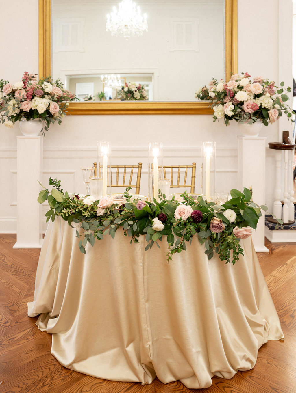 Classic Wedding Reception Decor, Sweetheart Table Champagne Table Linen, Greenery Garland with Mauve and White Roses, Candlesticks, Gold Chiavari Chairs | Tampa Bay Wedding Rentals Kate Ryan Event Rentals