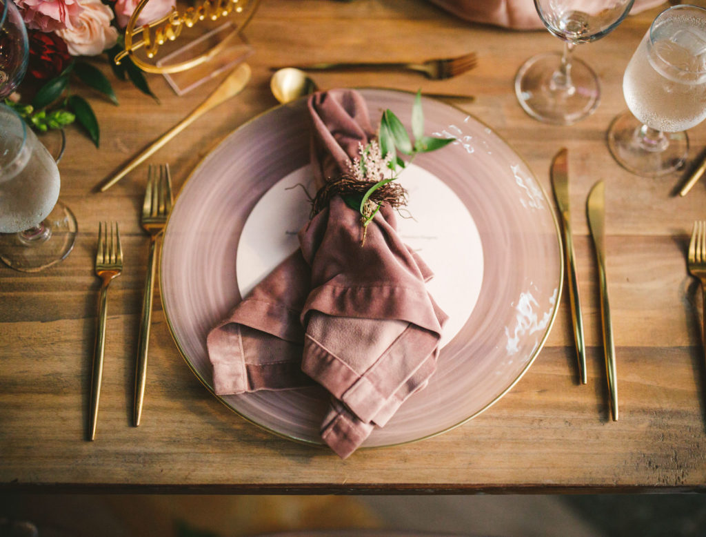 Luxury Elegant Tampa Wedding Reception Place Setting with Smoke Mauve Glass Charger Plates with Dusty Rose Velvet Napkins with Greenery Sprig and Gold Flatware