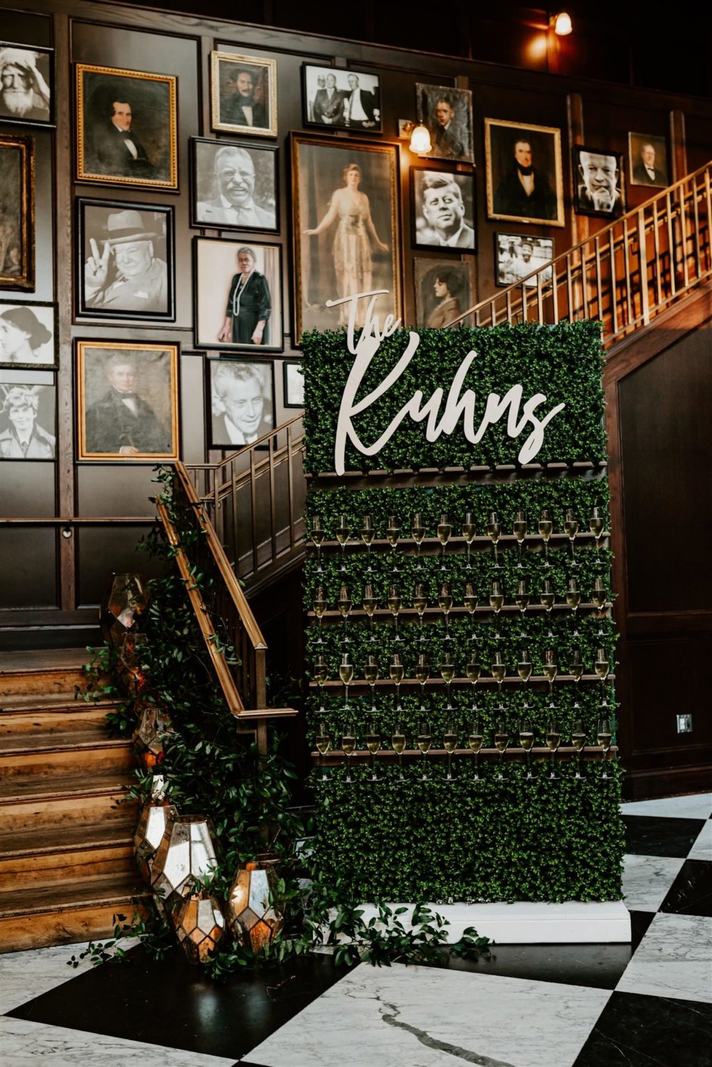 Downtown Tampa Historic Industrial Wedding with Boxwood Greenery Hedge Wall Champagne Shelf and Custom Name Sign | Wedding Staircase with Greenery Vines and Mercury Glass Lantern Candles | Winsor Event Studio