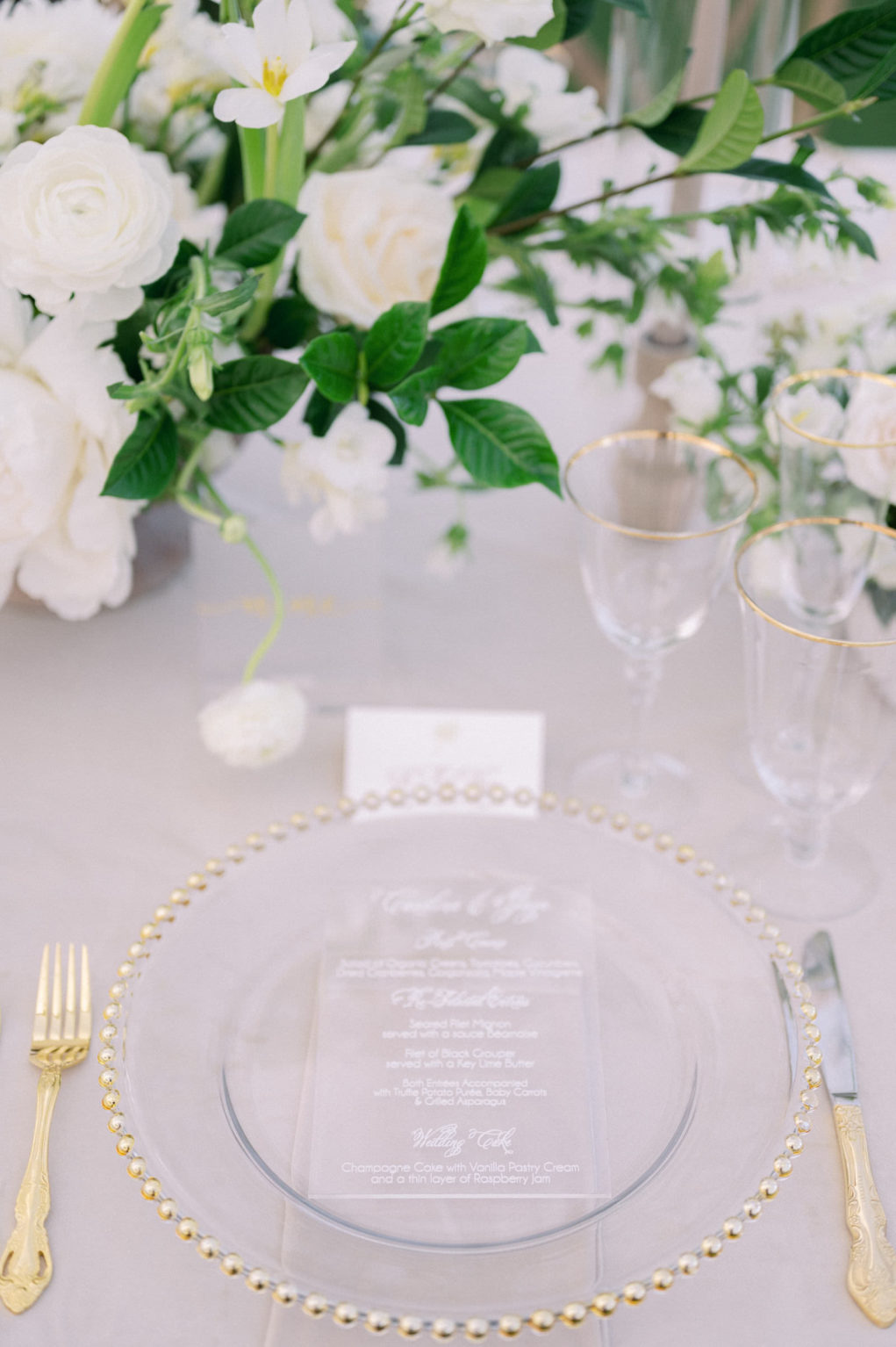 Luxurious Elegant Florida Classic Wedding Reception Decor, Gold Beaded and Clear Chargers, Gold Flatware, White Roses and Greenery Floral Centerpiece