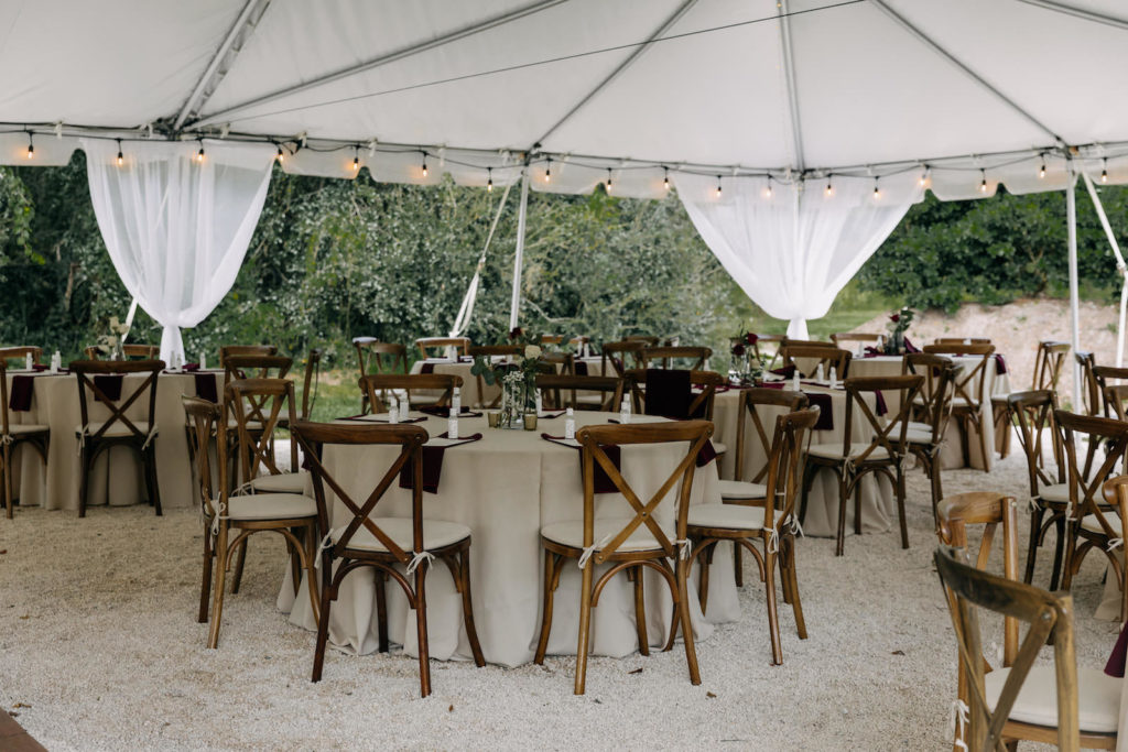 Outdoor Tent Wedding Reception Decor, Wooden Crossback Chairs, Oatmeal Table Linens, String Lights | Tampa Bay Wedding Photographer Amber McWhorter Photography | Wedding Venue The Secret Garden at Paradise Spring