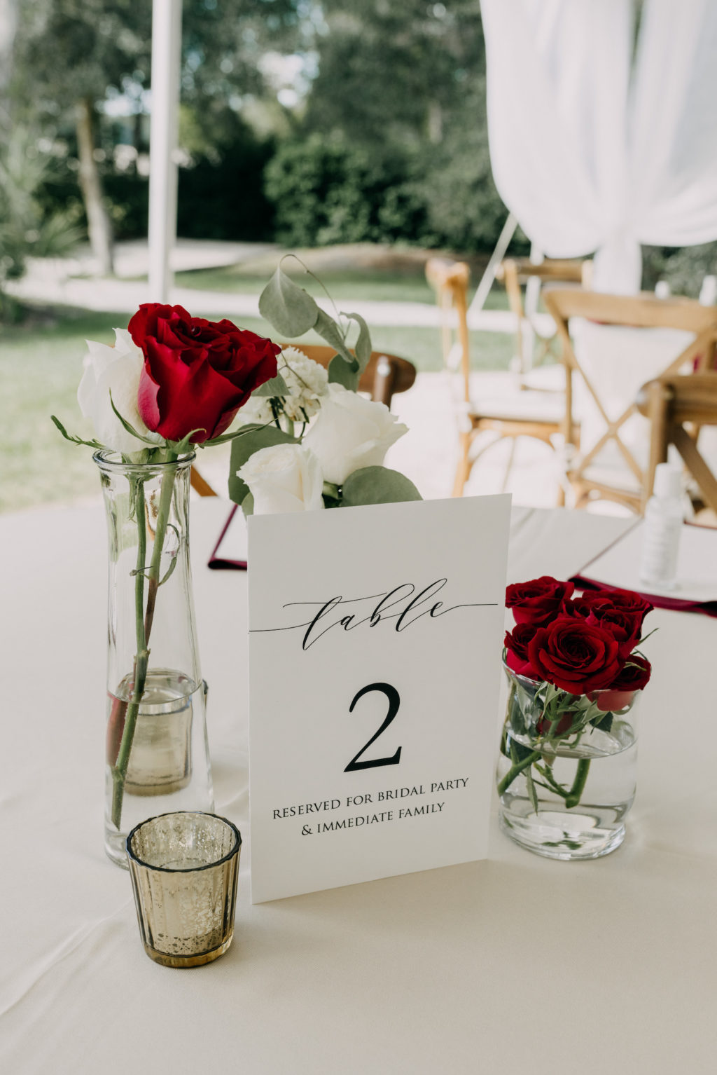 Garden Outdoor Tent Wedding Reception Decor, White and Red Roses Single Stem Flower Centerpieces, White Cardstock Table Number Signage | Tampa Bay Wedding Photographer Amber McWhorter Photography | Wedding Florist Brides & Blooms