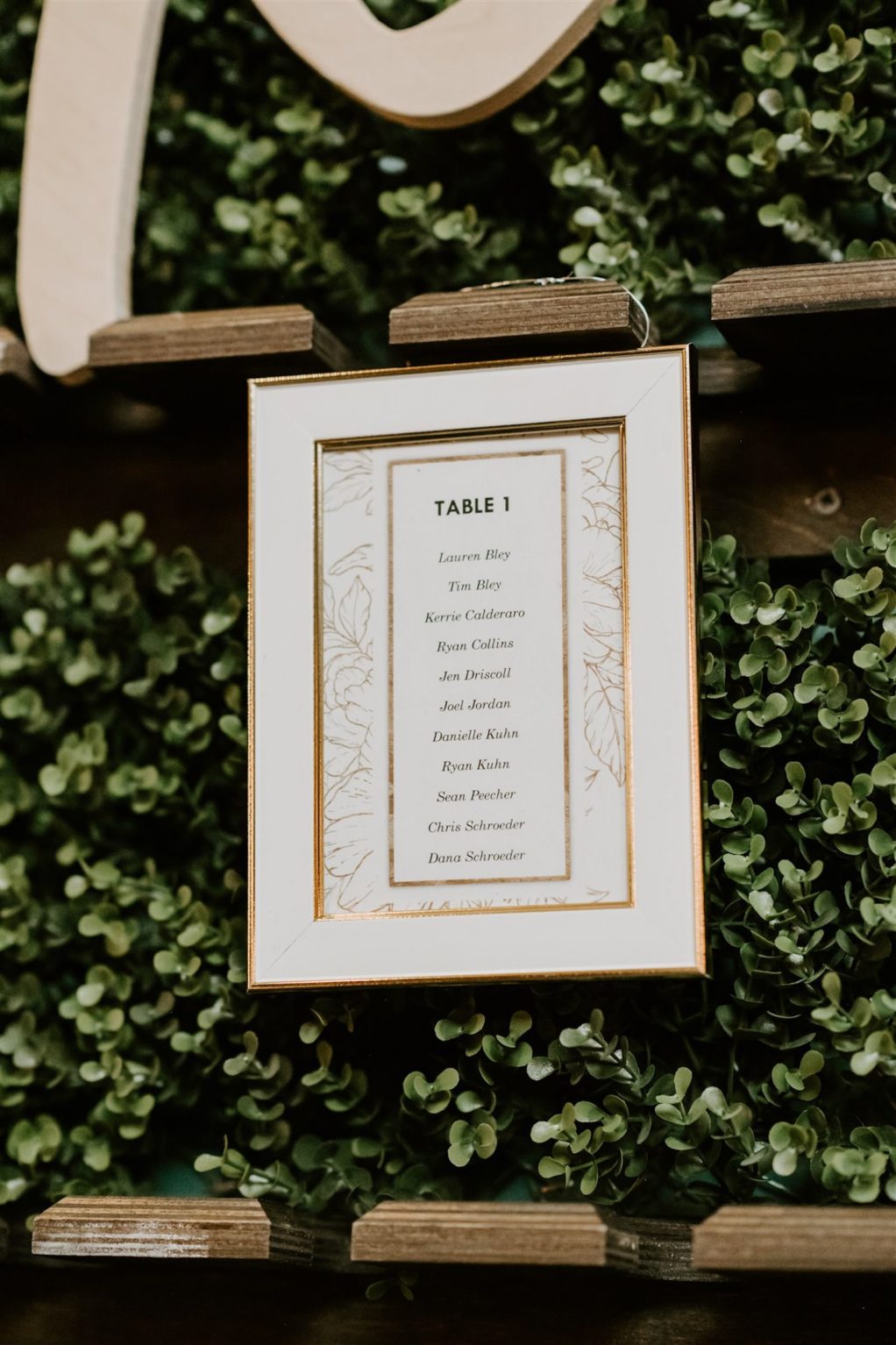 Tampa Wedding Seating Chart Boxwood Hedge Wall with White and Gold Framed Table Assignments