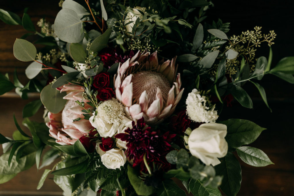 Romantic Garden Inspired Dark Floral Bouquet, Greenery, Eucalyptus, Pink King Proteas, White Roses and Dark Red Bridal Floral Bouquet | Tampa Bay Wedding Photographer Amber McWhorter Photography | Wedding Florist Brides & Blooms