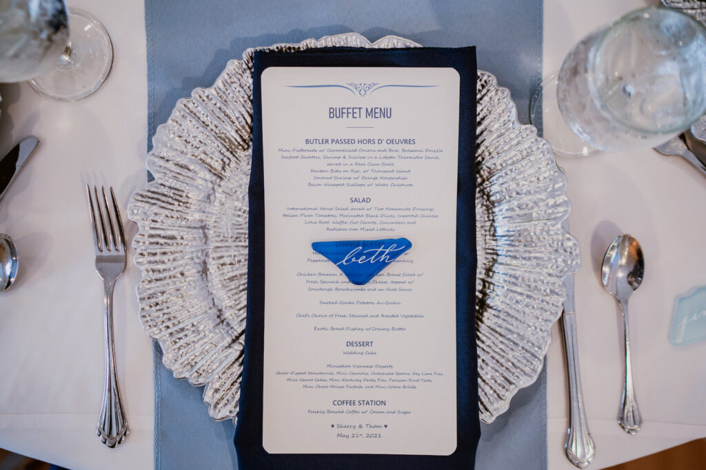 Wedding Reception Menu on Silver Scalloped Charger and Dusty Blue Table Runner and Seaglass Calligraphy Place Card