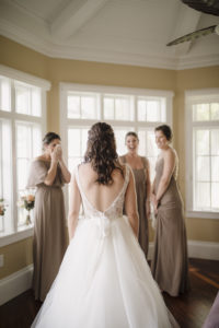 Bride in Low Back Lace Detail Ballgown Wedding Dress | Florida Bride in her Dress First Look with Bridesmaids | Bridesmaids in Mix and Match Taupe Bridesmaid Dresses Portrait | Paloma Blanca, Overskirt: Hayley Paige Ballgown | Bridesmaids in Show Me Your MuMu