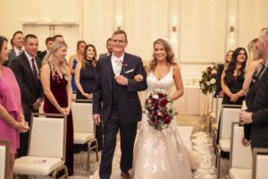 Florida Bride Walking with Dad Down the Wedding Ceremony Aisle Holding Burgundy Roses Floral Bouquet
