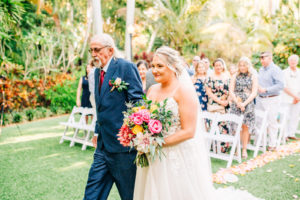 Father Walking his Daughter Down the Wedding Ceremony Aisle | Bride in Nikki's Glitz and Glam - Morilee by Madeline Gardner | Bright Colored Wedding Bouquet