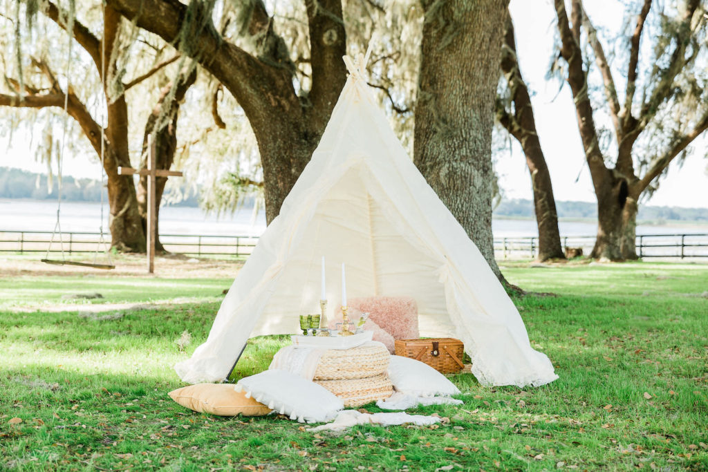 Intimate Wedding Details | White Tent and Bohemian Pillow Set up with Candles and Vintage Touches