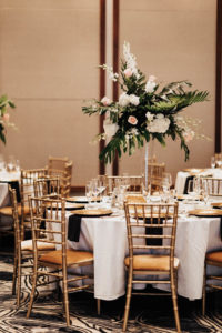 Gold Chiavari Wedding Chairs and White Linen Tables with Tall Tropical Floral and Greenery Centerpieces | Tampa Bay Rental Company Kate Ryan Event Rentals