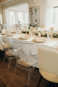 Timeless Elegant Wedding Reception Decor, Long Feasting Table, Acrylic Chairs, White Roses and Greenery Garland, Candlesticks, Gold Chargers | Tampa Bay Wedding Venue Westshore Yacht Club