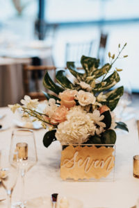 Gold Acrylic Table Numbers with Handwritten Writing | Blush and White Floral Centerpieces with Tropical Greenery