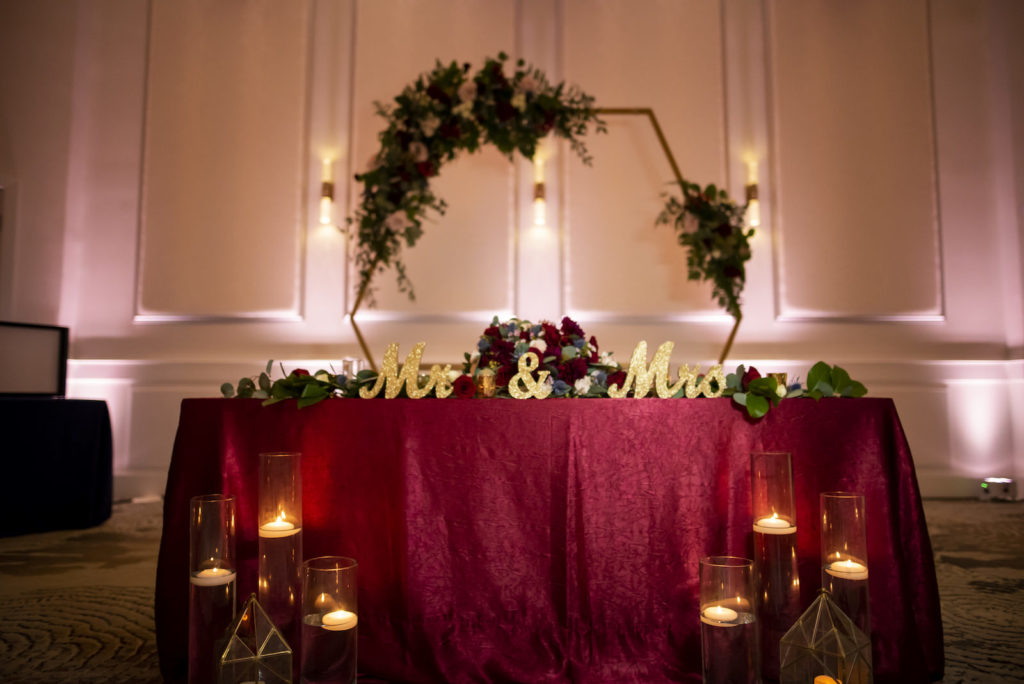 Burgundy and Gold Sweetheart Table with Geometric Arch Backdrop