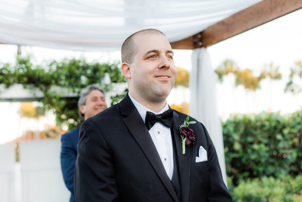 Florida Groom Reaction to Bride Walking Down the Wedding Ceremony Aisle Wearing Black Tuxedo with Bow Tie