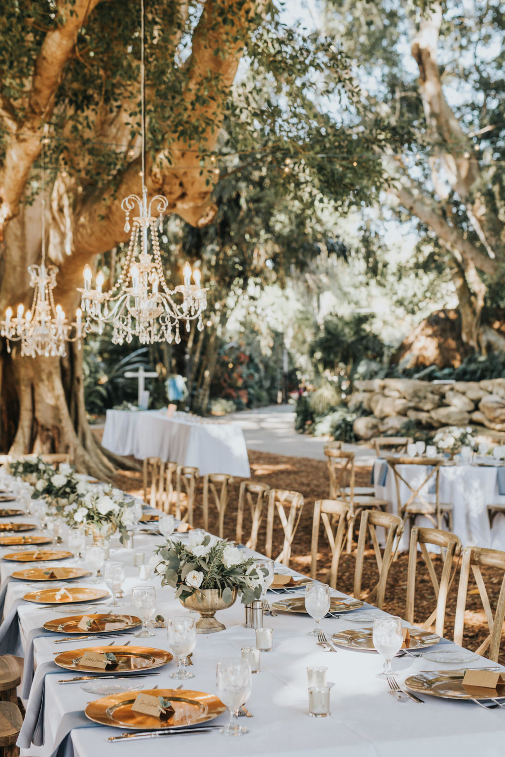 Romantic Rustic Outdoor Garden Wedding Reception | Sarasota Marie Selby Botanical Gardens | Gold Chargers and French Country Wooden Reception Chairs | Crystal Chandeliers Hanging from Trees | Sarasota Wedding Planner Taylored Affairs