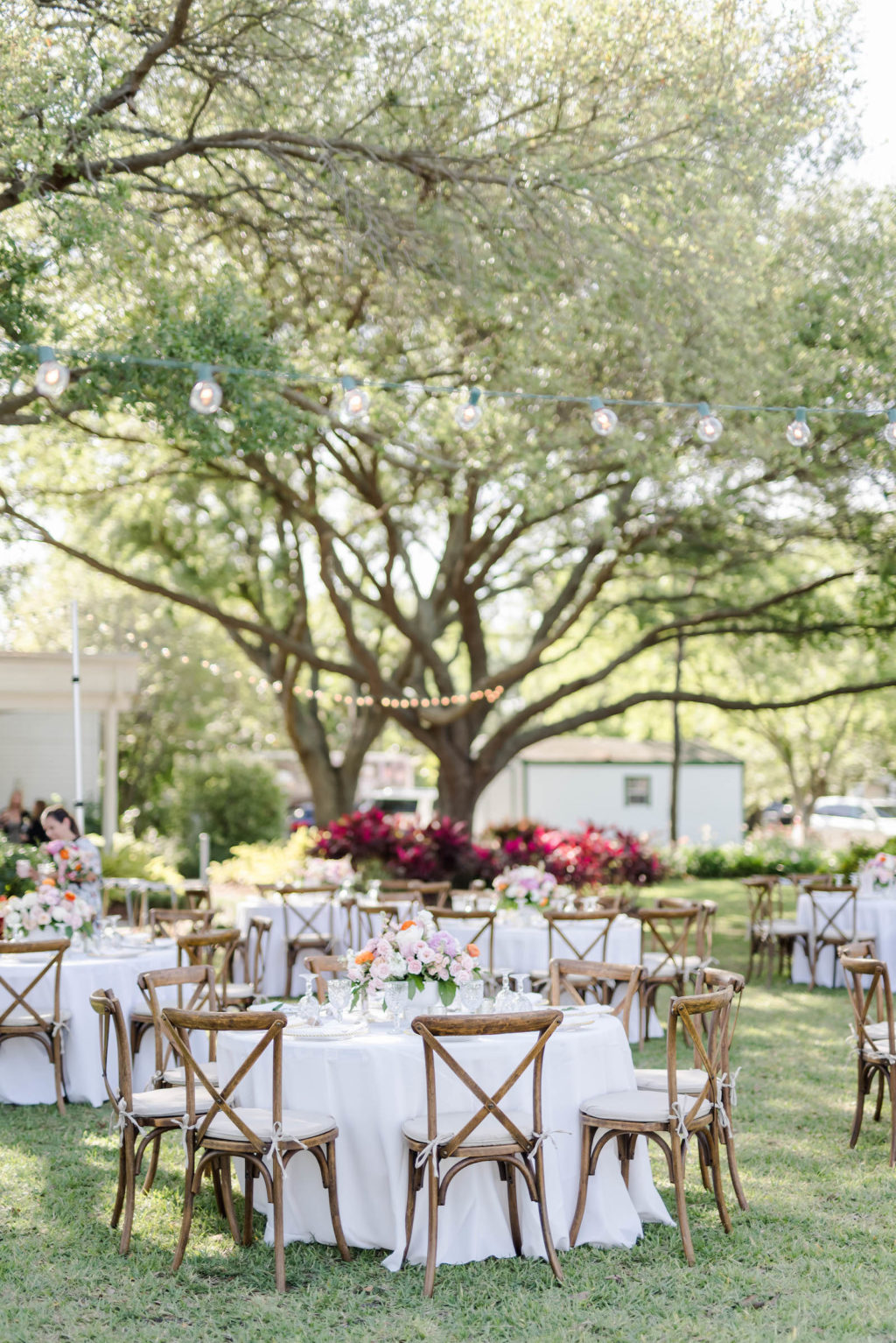 Outdoor Garden Wedding Reception with Wooden French Country Chairs, Round Tables with White Linens and String Lights | Tampa Bay Rental Company Outside the Box Event Rentals | Wedding Planner Special Moments Event Planning | Venue Davis Islands Garden Club