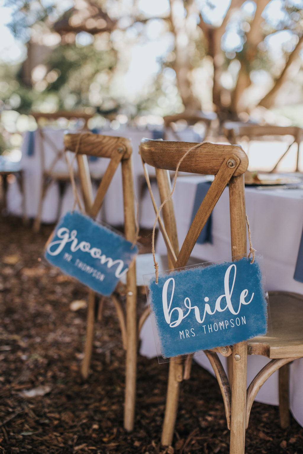 Bride and Groom Blue Wedding Chair Signs on Wooden French Country Chairs | Outdoor Rustic Wedding Reception Ideas