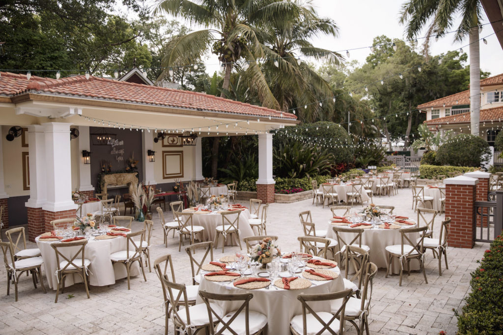 Outdoor Boho Wedding Reception with Rustic Wooden French Country Chairs, Round Tables with Cream Linens and String Lights | Tampa Bay Rental Company Kate Ryan Event Rentals | Sarasota Wedding Venue Palmetto Riverside Bed and Breakfast