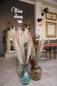 Neon Sign and Pampas Leaves in Large Clear Vases with Greenery | Boho Wedding Reception Décor Ideas