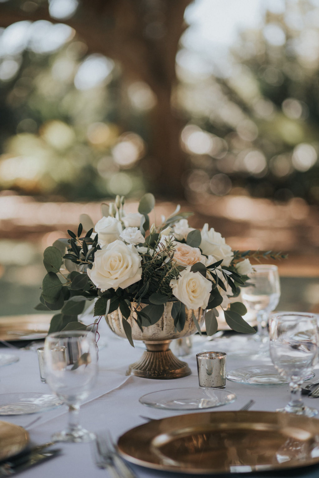 White and Ivory Centerpieces with Greenery with Gold Chargers | Romantic Rustic Outdoor Garden Wedding Reception with White Linens