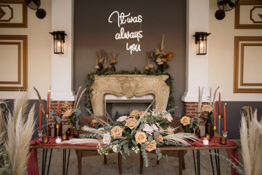 Wedding Neon Sign and Pampas Leaves in Large Clear Vases with Greenery | Boho Wedding Reception Décor with Sweetheart Table | Kate Ryan Event Rentals | Sarasota Wedding Planner Kelly Kennedy Weddings and Events