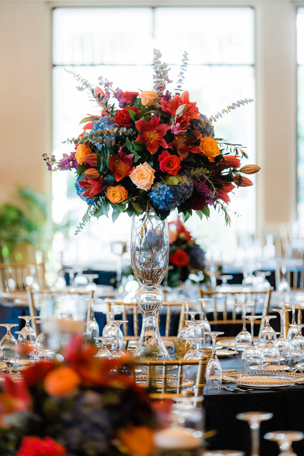 Elegant Ballroom Wedding Reception Decor, Silver Chiavari Chairs, Round Tables with Navy Blue Table Linens, Jewel Tone Tall Floral Centerpieces, Blue, Pink, Red, Orange Flowers | Tampa Wedding Venue The Resort at Longboat Key Club
