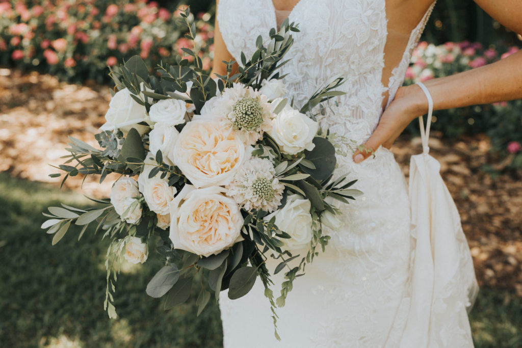 Romantic Garden Rustic White and Cream Wedding Bouquet with Greenery Detail | Bride in Long Train Sweetheart Wedding Dress with Lace Detail with Spaghetti Straps | Essense of Australia Wedding Gown