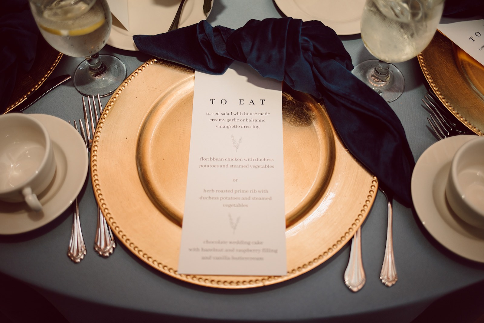 Gold Charger and Modern Wedding Menu with Navy Napkin Place Setting