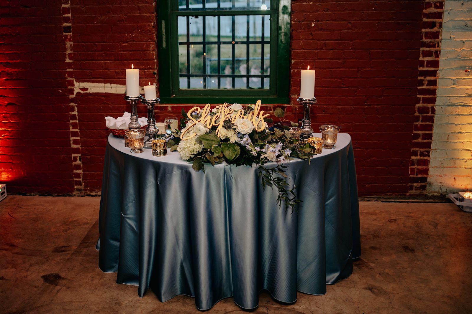 Dusty Blue Linen Sweetheart Table Candlelit with Florals
