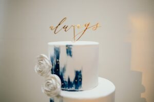 Three Tier Modern Wedding Cake with Blue Detailing and Gold Cake Topper