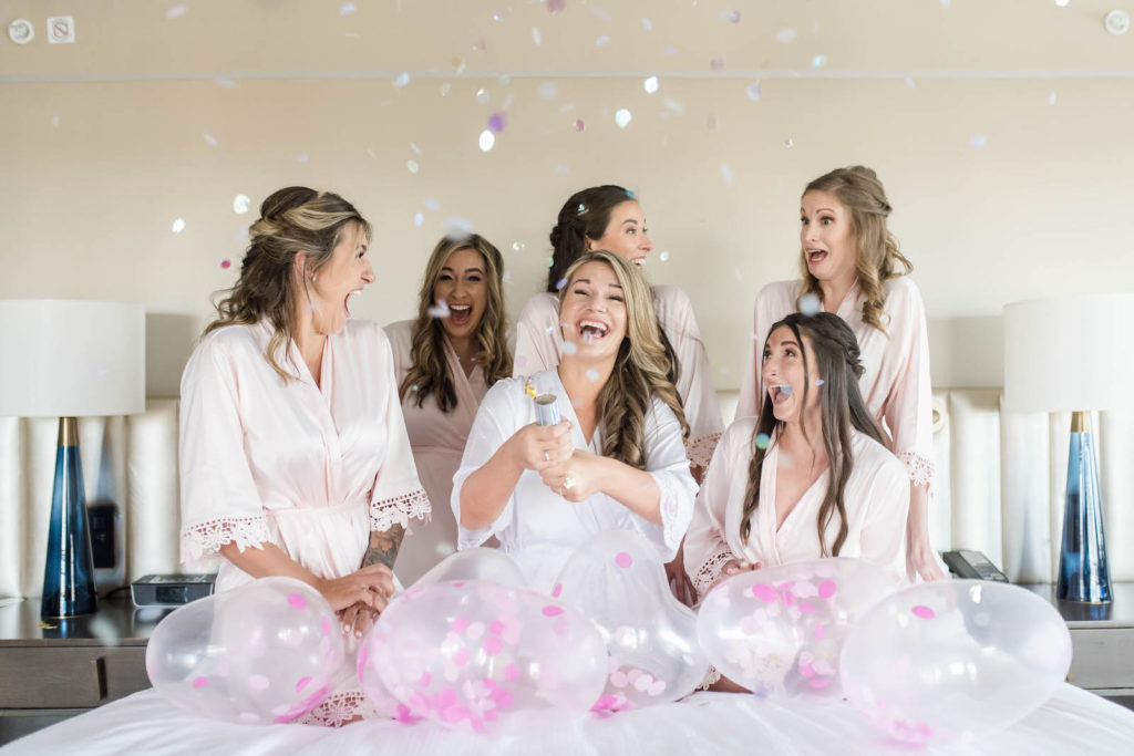 Bridesmaids in Matching Pink Robes and Big “Bride” Balloons Photo | Getting Ready Bridal Party Inspiration