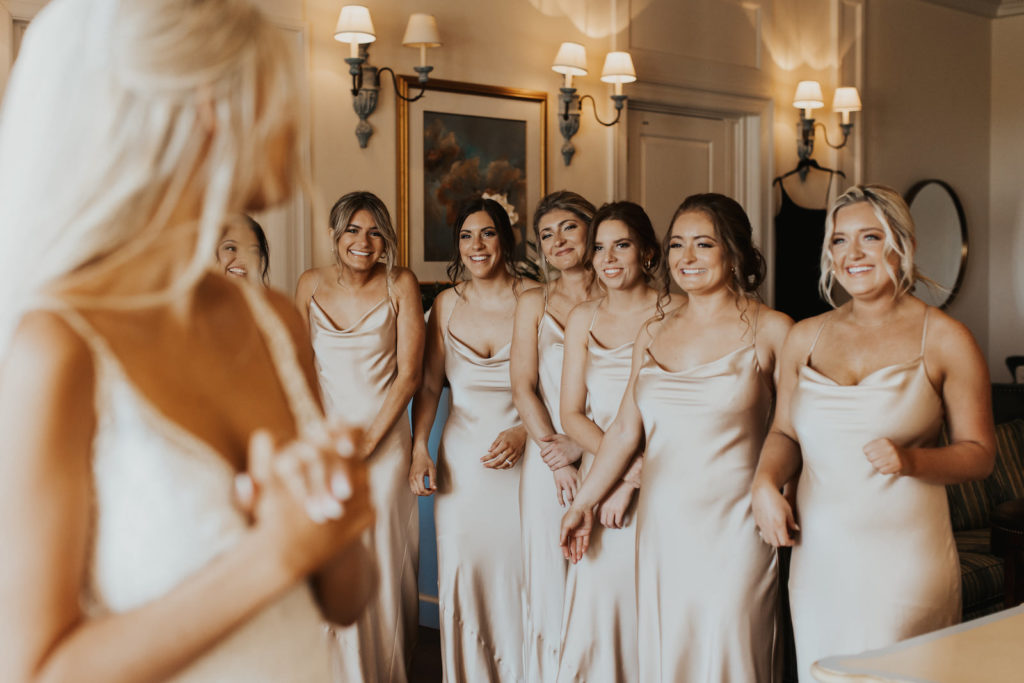 Bride First Look with Bridesmaids in Matching Champagne Gold Silky Dresses