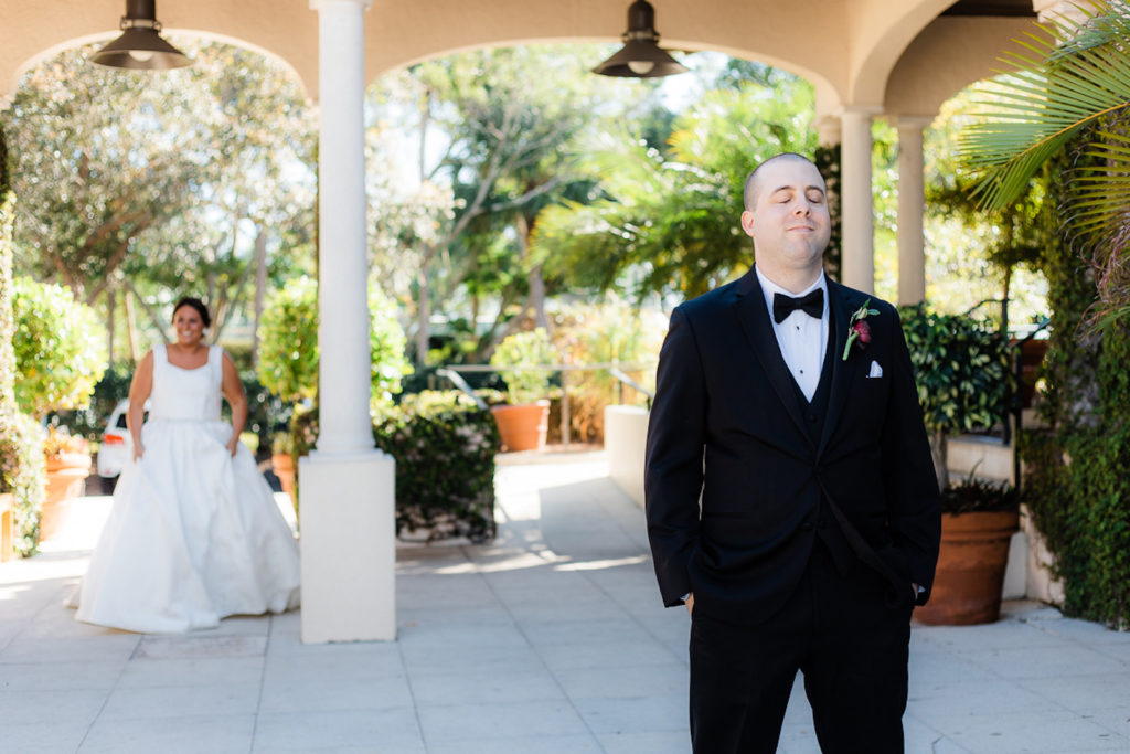 Bride and Groom First Look Wedding Photo, Groom Back to Bride Wearing Black Tuxedo