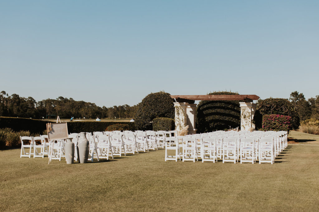 Outdoor Golf Course Wedding Ceremony Decor, Pergola, White Folding Chairs | Bradenton Wedding Venue The Concession Golf Club