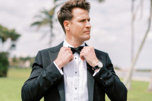 Florida Groom Adjusting Black Bowtie in Tuxedo | Tampa Bay Wedding Photographer Kera Photography