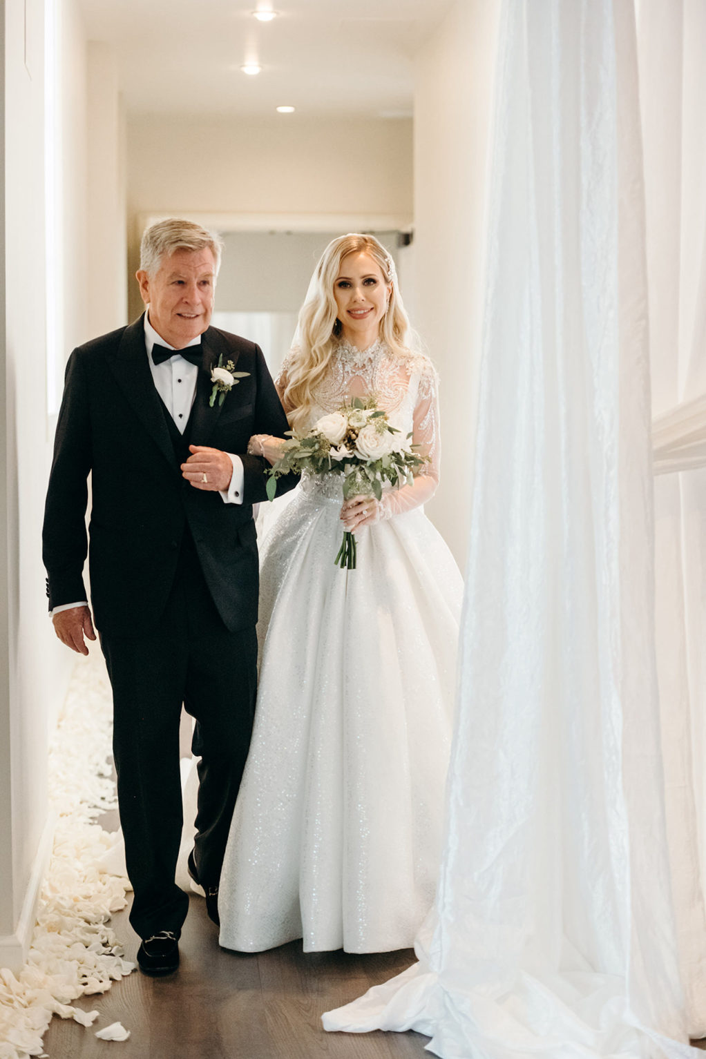Classic Elegant Bride in Ballgown Wedding Dress with Long Sleeve Embellished Illusion Bodice Walking with Father Down the Wedding Ceremony