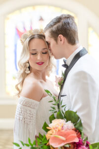 Intimate Florida Bride Wearing Lace and Fringe Off the Shoulder Sleeve, Gold and Ivory Flower Crown, Groom Wearing White and Black Collar Tuxedo Wedding Portrait | Wedding Hair and Makeup Adore Bridal Hair and Makeup