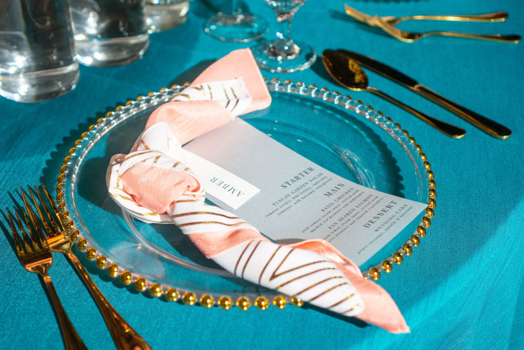 Modern Florida Wedding Reception Decor, Teal Linens, Gold Beveled Crystal Charger with Pink Striped Napkin and Custom Menu Stationary, Gold FlatwareGhost Chiavari Chairs | 7th and Grove