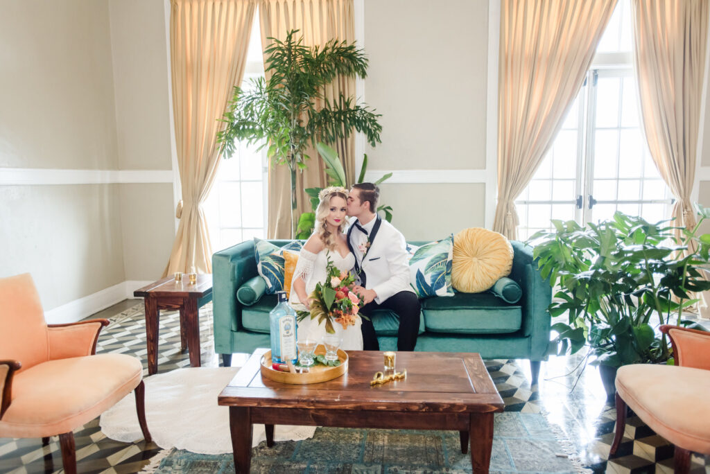 Florida Bride and Groom Sitting on Turquoise Velvet Couch at Tampa Historic Wedding Venue The Cuban Club | Wedding Planner Eventfull Weddings | Tabletop Wedding Rentals A Chair Affair | Wedding Hair and Makeup Adore Bridal Hair and Makeup