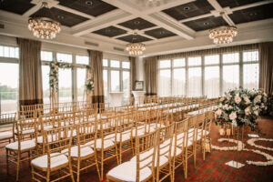 Romantic Indoor Ballroom Wedding Ceremony with Gold Chiavari Chairs | St. Pete Rental Company Gabro Event Services | Venue The Birchwood | Tampa Bay Planner Perfecting the Plan