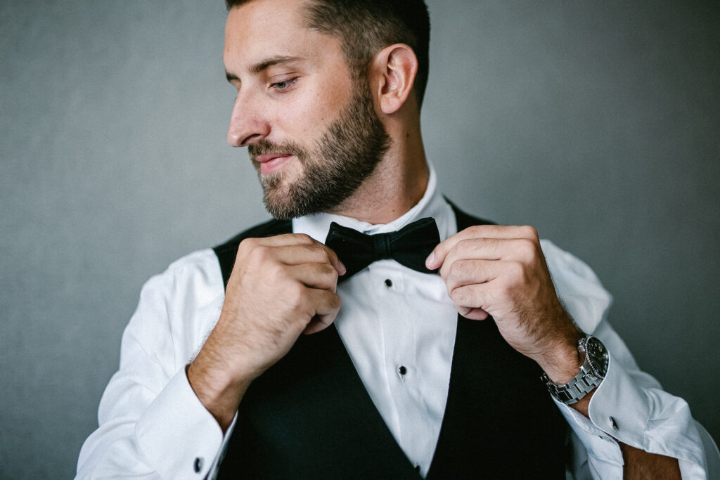Tampa Groom Getting Wedding Ready in Black Tuxedo Vest and Bowtie