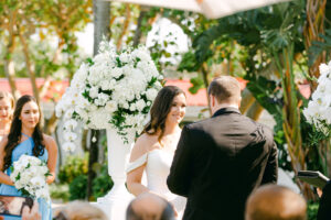 Tampa Bay Bride and Groom Exchange Vows During Outside Ceremony, Alter with Towering Florals Arrangements, White Orchids, Ivory Roses, Hydrangeas | Tampa Bay Florist Bruce Wayne Florals | Florida Wedding Planner Parties A La Carte