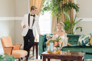 Florida Bride and Groom Sitting on Turquoise Velvet Couch at Tampa Historic Wedding Venue The Cuban Club | Wedding Planner Eventfull Weddings | Tabletop Wedding Rental A Chair Affair | Wedding Hair and Makeup Adore Bridal Hair and Makeup