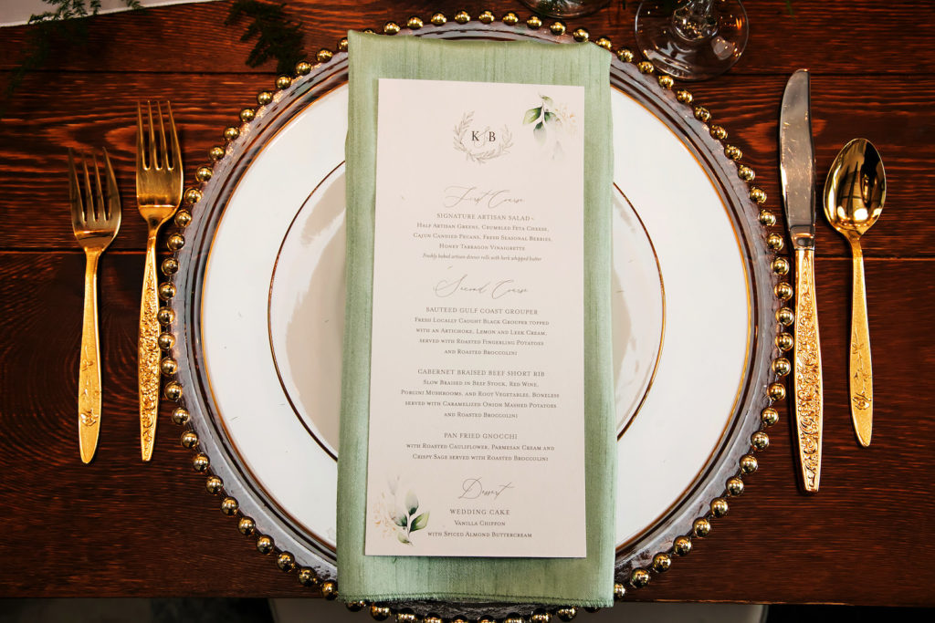 Romantic Wedding Reception Decor, Long Wooden Table, Clear and Gold Beaded Charger, Gold Flatware, Sage Green Linen Napkin, Custom Menu, White and Gold China Dinner Plate | Tampa Bay Wedding Photographer Limelight Photography | Wedding Planner MDP Events | Wedding Stationery A&P Design Co.