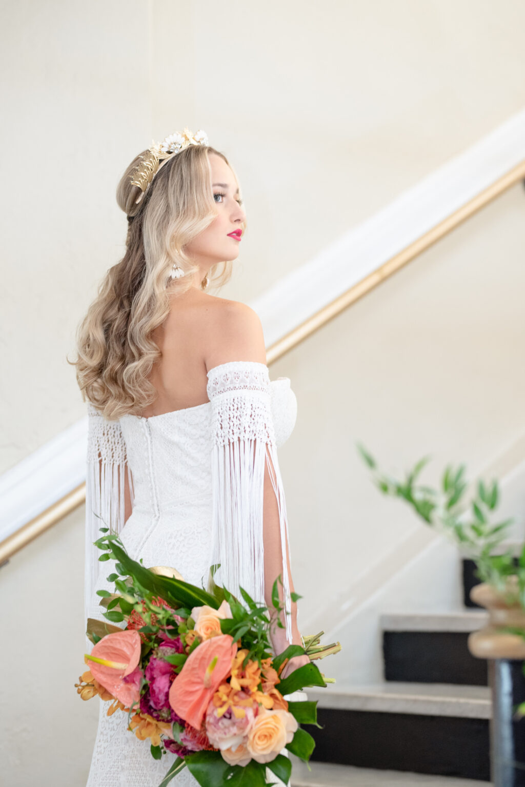 Florida Bride Wearing Vintage Lace and Fringe Off the Shoulder Sleeve Wedding Dress and Gold, Flower Crown Holding Colorful Tropical Floral Bouquet, Pink Anthuriums, Monstera Palm Leaves | Tampa Bay Wedding Planner Eventfull Weddings | Wedding Hair and Makeup Adore Bridal Hair and Makeup