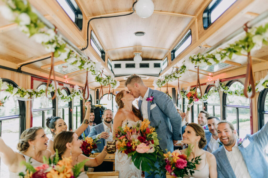 Bride and Groom Kissing on Trolley Train with Bridesmaids and Groomsmen | Tampa Bay Wedding Photographer Amber McWhorter Photography
