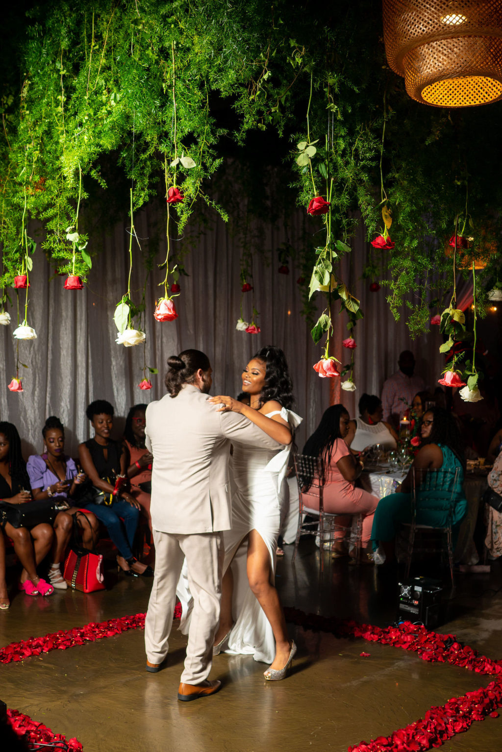 Modern Florida Bride and Groom First Dance Under Suspended Florals, Dance Floor Sounded by Rose Petals | Tampa Bay Event Venue 7th and Grove