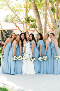 Tampa Bay Bride and Bridal Party, Bridesmaids in Long Slate Blue Mismatched Dresses Holding White Floral Bouquets, Bride Wearing Off The Shoulder Stella York Gown, With Cascading Orchid Bridal Bouquet | Florida Wedding Florist Bruce Wayne Florals
