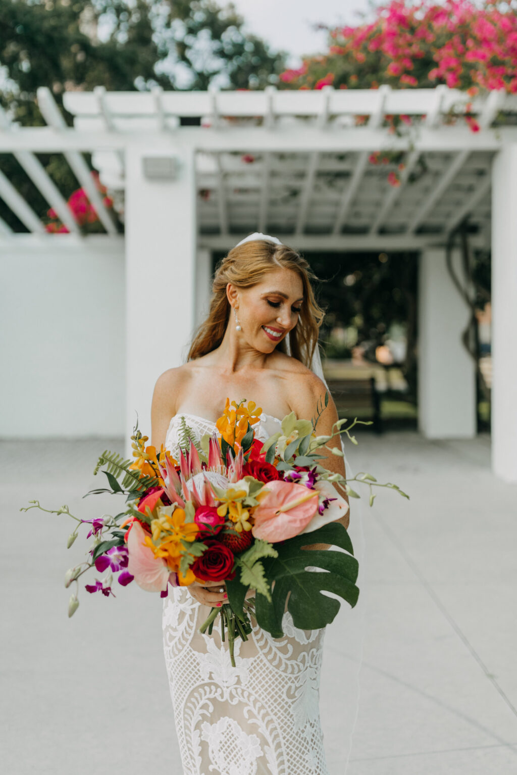 Boho Bride Holding Tropical Colorful Floral Bouquet, King Protea, Monstera Palm Leaf, Purple Orchids, Red Roses, Pink Anthurium, Orange Flowers | Tampa Bay Wedding Photographer Amber McWhorter Photography | Wedding Hair and Makeup Femme Akoi Beauty Studio