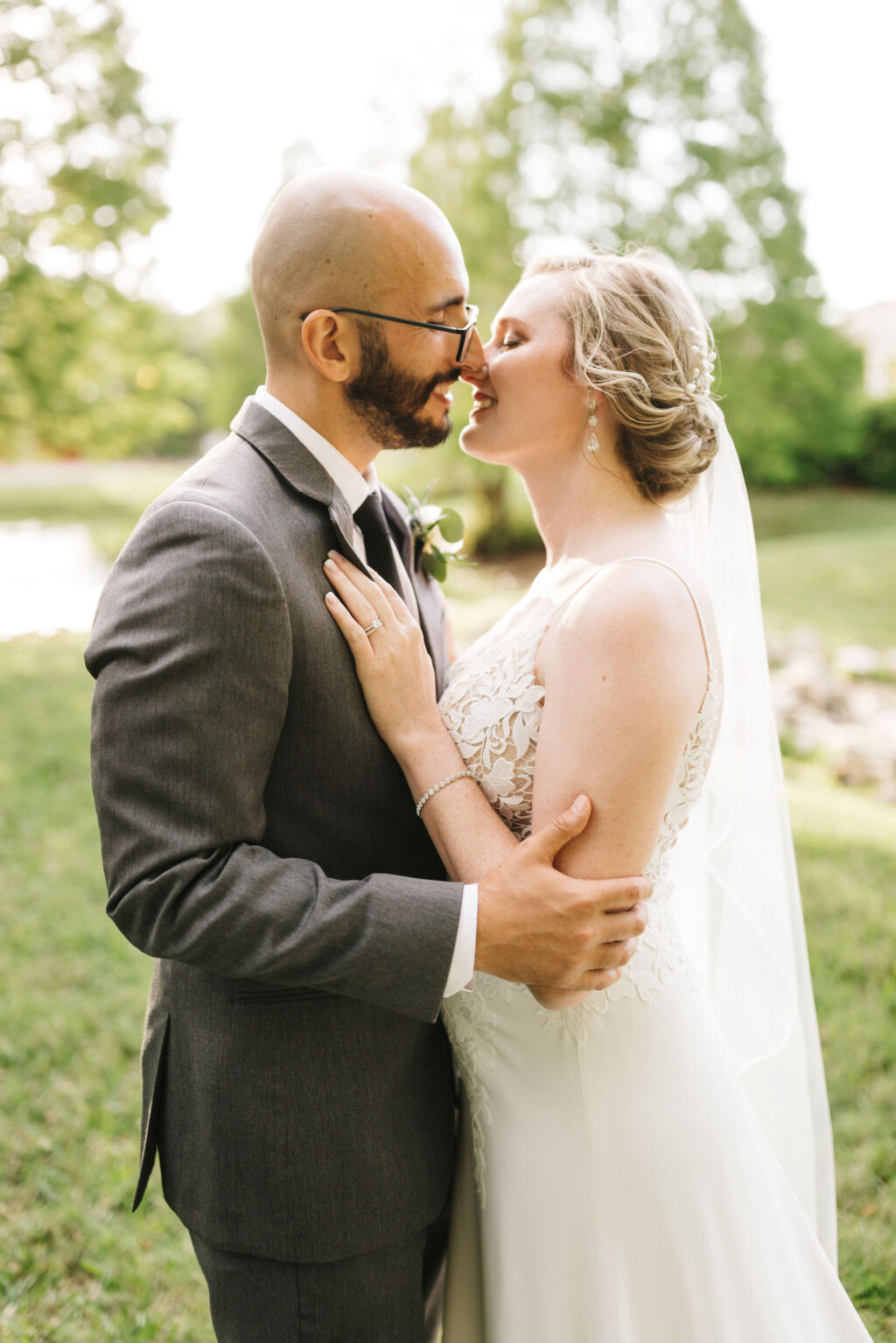 Bride and Groom Outdoor Wedding Portrait | Sheath Satin Charmeuse V Neck Lace Bodice Spaghetti Strap Bridal Gown | Groom Wearing Classic Charcoal Grey Suit | Michele Renee the Studio